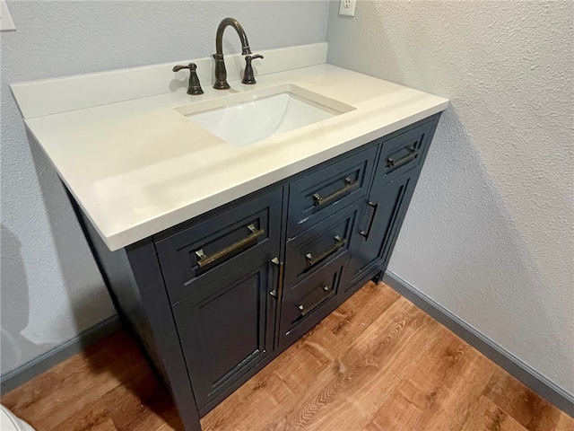 bathroom featuring hardwood / wood-style flooring and vanity