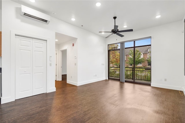 interior space featuring an AC wall unit, dark wood-type flooring, and ceiling fan