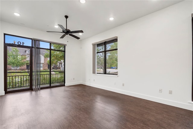 spare room with dark wood-type flooring and ceiling fan