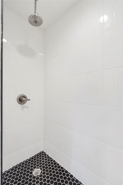 bathroom with tiled shower