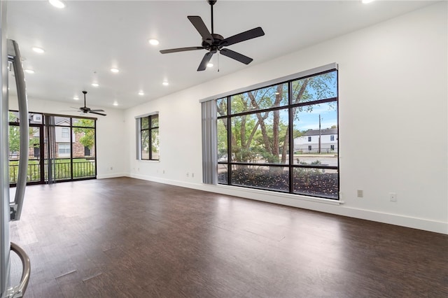 unfurnished room with dark wood-type flooring and a healthy amount of sunlight