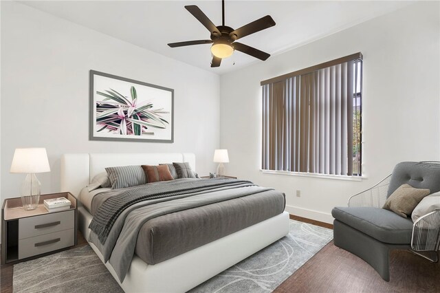 bedroom with dark hardwood / wood-style floors and ceiling fan