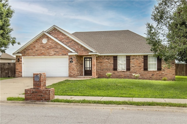 view of front facade featuring a front yard and a garage