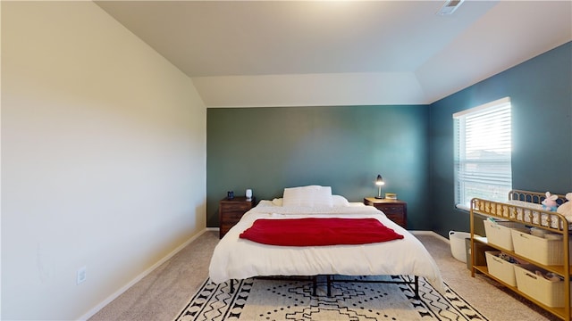 bedroom with light carpet and vaulted ceiling