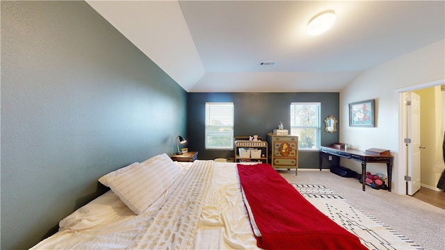 carpeted bedroom with vaulted ceiling