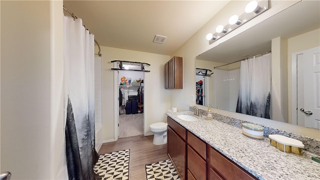 bathroom featuring wood-type flooring, vanity, and toilet