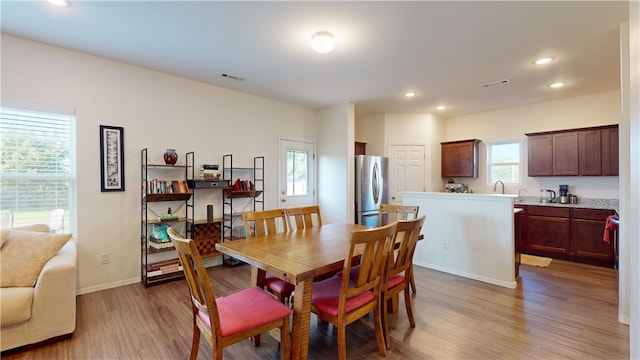 dining room featuring sink and hardwood / wood-style flooring