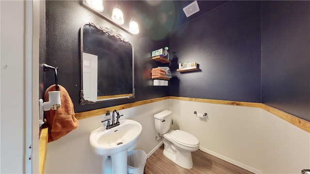 bathroom featuring hardwood / wood-style floors, toilet, and sink