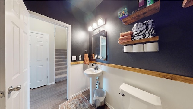 bathroom with hardwood / wood-style floors and toilet