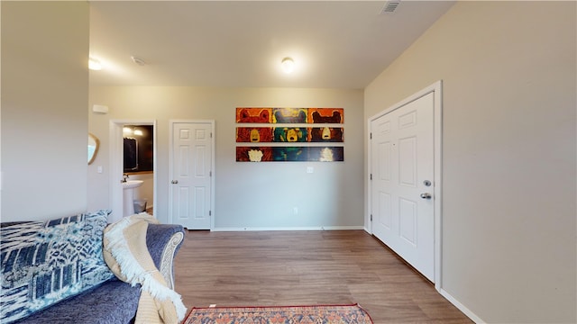 interior space featuring ensuite bath and hardwood / wood-style floors