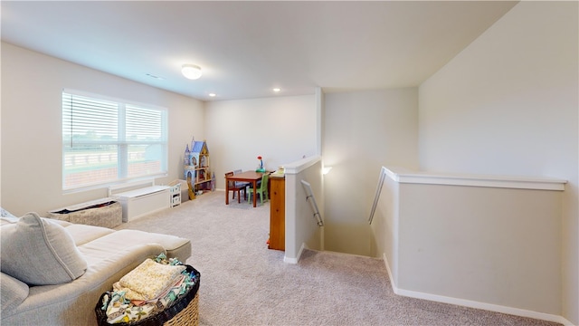 living area with light carpet