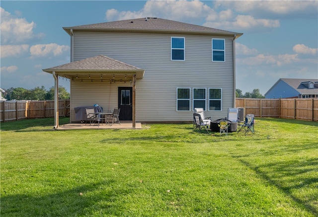 back of property featuring a lawn and a patio area