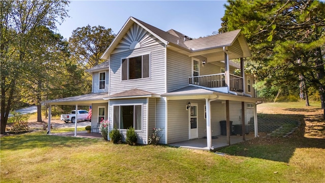 rear view of property featuring a patio, a carport, and a lawn