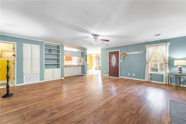 unfurnished living room featuring wood-type flooring, a textured ceiling, ornamental molding, and ceiling fan