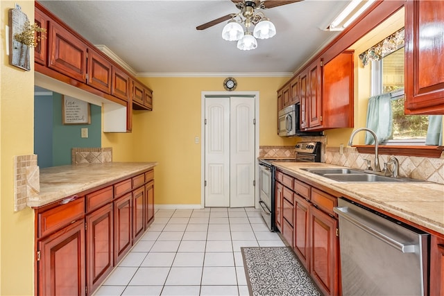 kitchen with light tile patterned flooring, decorative backsplash, crown molding, sink, and stainless steel appliances