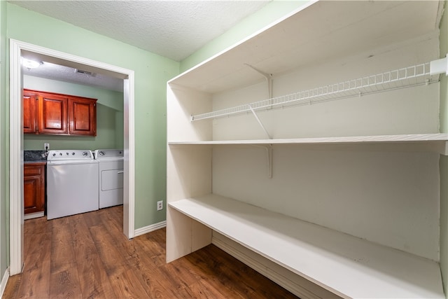 pantry with washer and clothes dryer