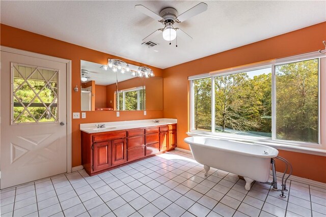 bathroom with a bathtub, tile patterned floors, ceiling fan, and vanity