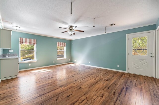 interior space featuring ceiling fan, hardwood / wood-style floors, and a textured ceiling