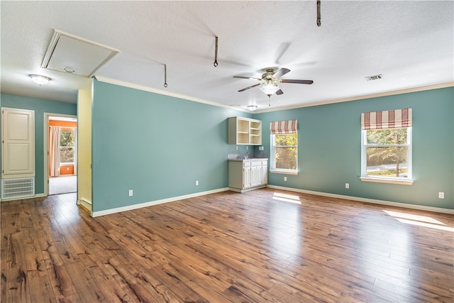 interior space featuring plenty of natural light, hardwood / wood-style flooring, and a textured ceiling