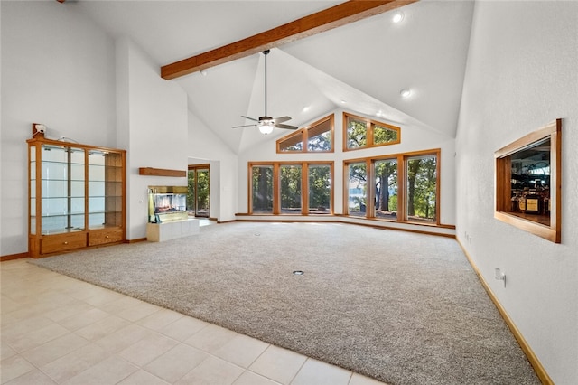 unfurnished living room with light colored carpet, high vaulted ceiling, beamed ceiling, and ceiling fan