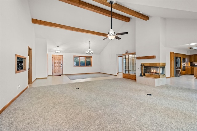 unfurnished living room featuring light carpet, ceiling fan with notable chandelier, beam ceiling, and high vaulted ceiling