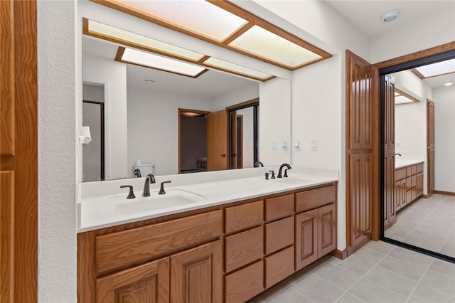 bathroom with tile patterned floors, vanity, and toilet