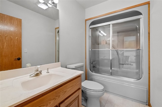 full bathroom featuring tile patterned floors, toilet, bath / shower combo with glass door, and vanity