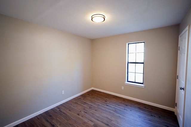 spare room with dark wood-type flooring