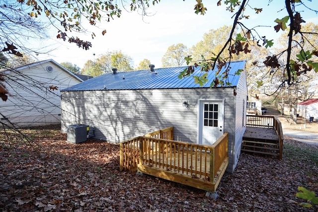 back of house featuring a wooden deck and central AC