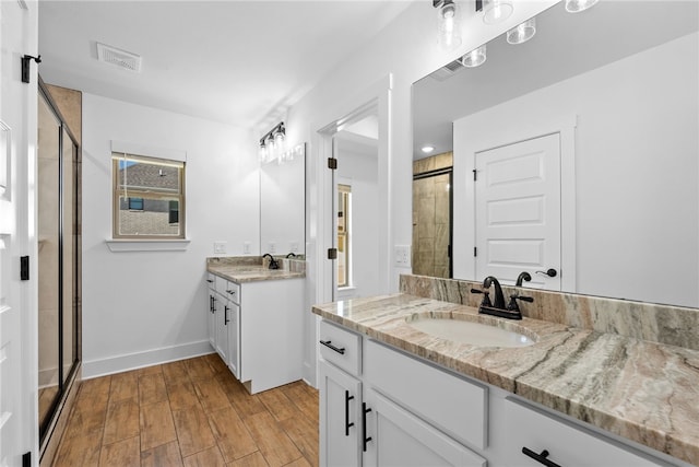 4206 SW Adams St, Bentonville, AR 72713 - full bath with a stall shower, two vanities, wood finished floors, and baseboards