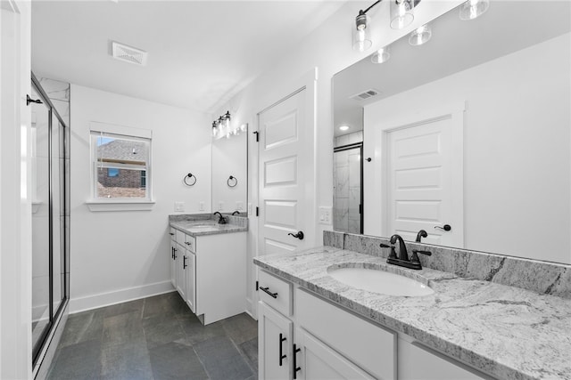 bathroom with vanity and a shower with door