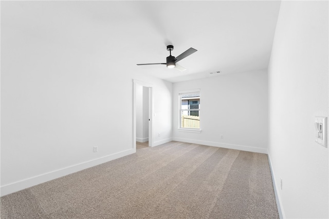 unfurnished room featuring light colored carpet and ceiling fan