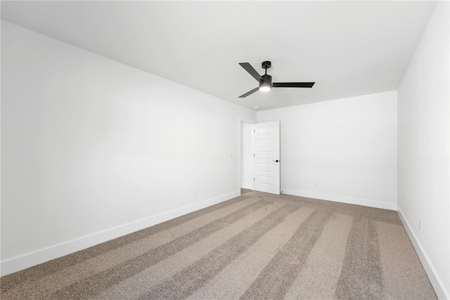 spare room with ceiling fan and carpet