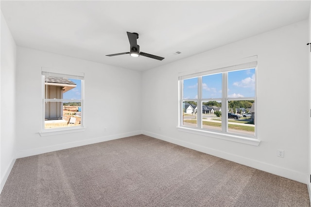 unfurnished room featuring ceiling fan and carpet flooring