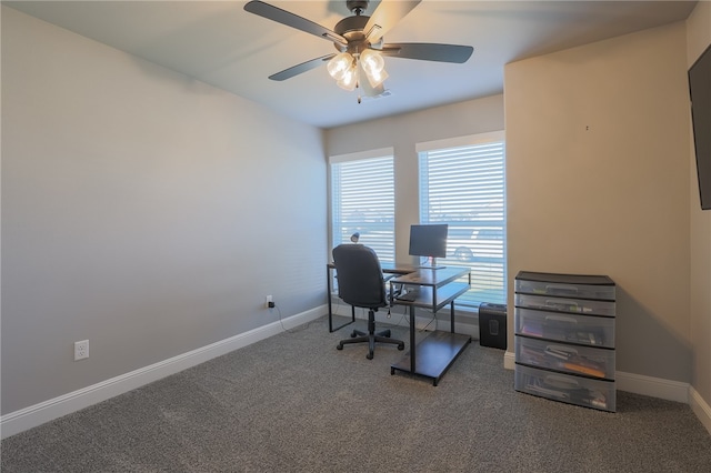 carpeted home office featuring ceiling fan