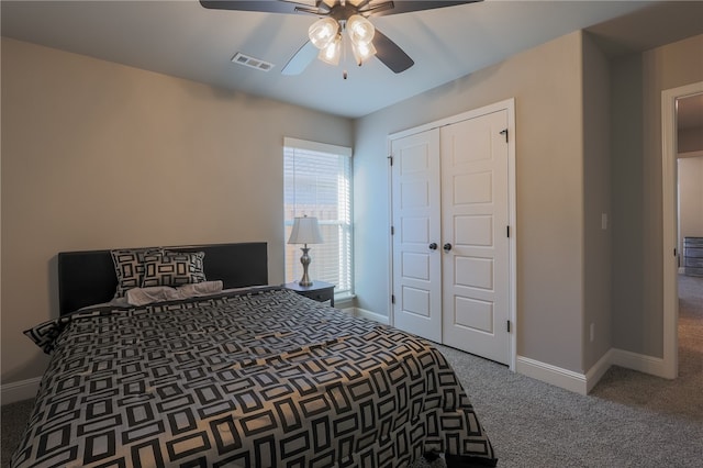 carpeted bedroom with ceiling fan and a closet