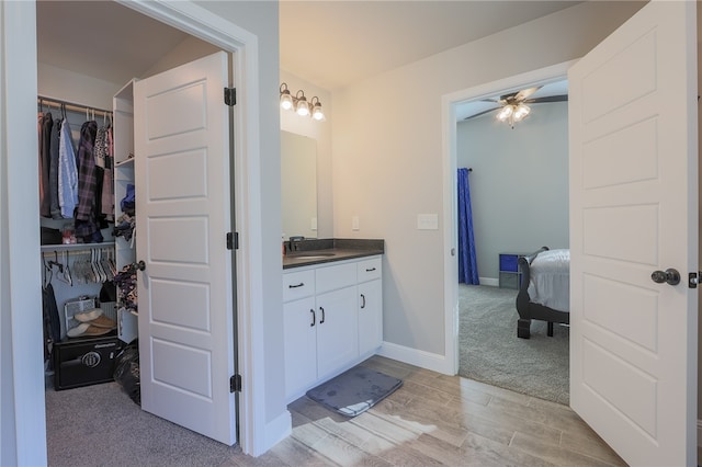 bathroom featuring ceiling fan and vanity