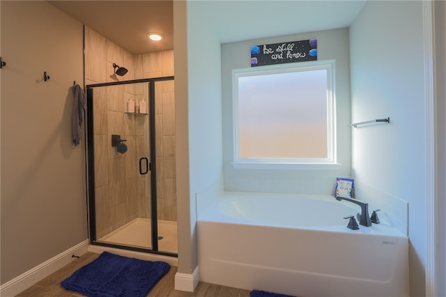 bathroom featuring shower with separate bathtub and hardwood / wood-style floors