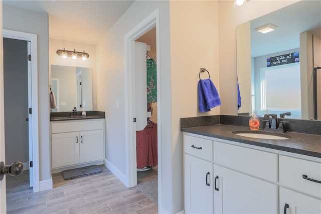 bathroom with vanity and hardwood / wood-style flooring