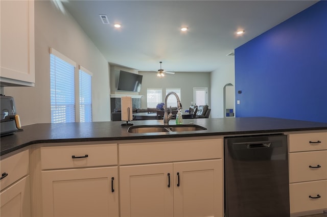 kitchen featuring black dishwasher, white cabinets, sink, and ceiling fan