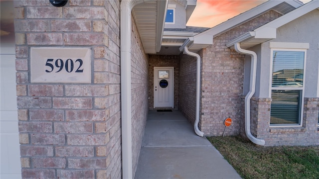 view of exterior entry at dusk