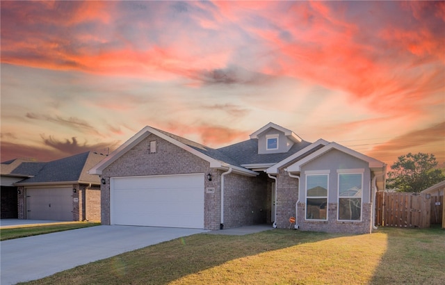 view of front of house with a garage and a yard