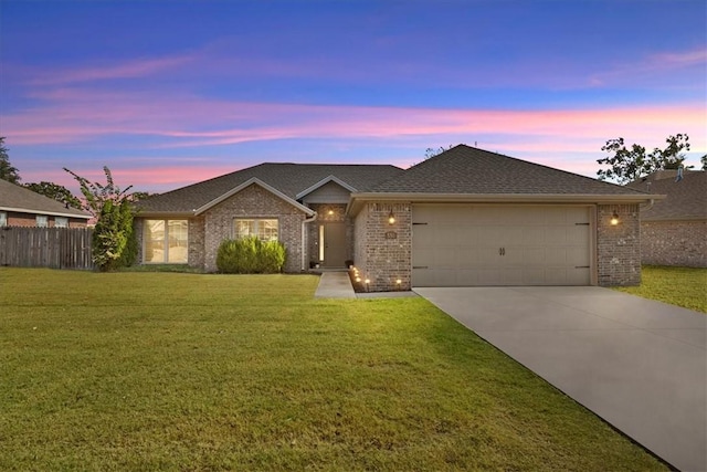 ranch-style house with a yard and a garage