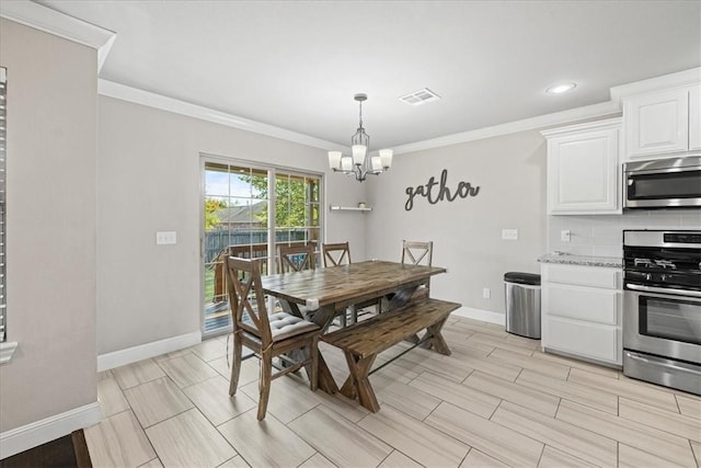 dining room with crown molding and an inviting chandelier