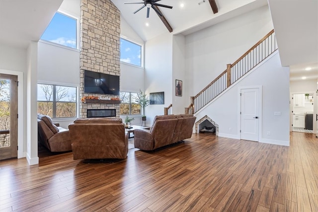 living room featuring a wealth of natural light, high vaulted ceiling, and hardwood / wood-style flooring