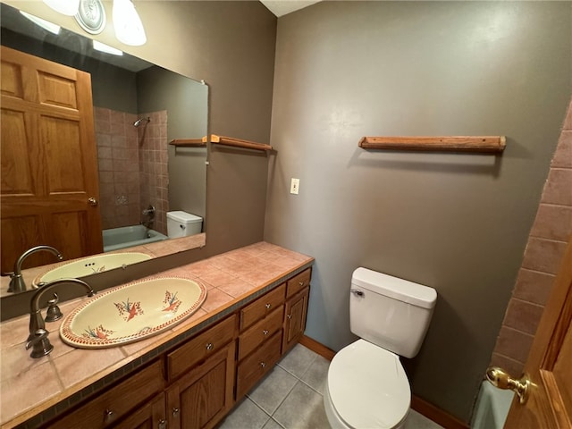 full bathroom featuring vanity, tiled shower / bath combo, toilet, and tile patterned floors