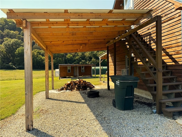 view of home's community featuring a yard, a shed, and a fire pit