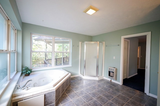 bathroom with heating unit and separate shower and tub