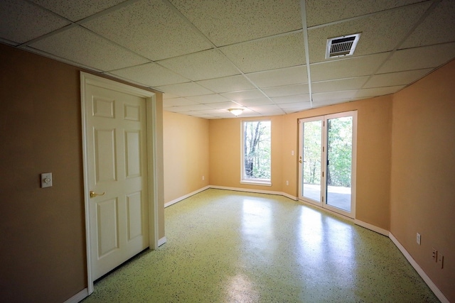 unfurnished room featuring a drop ceiling