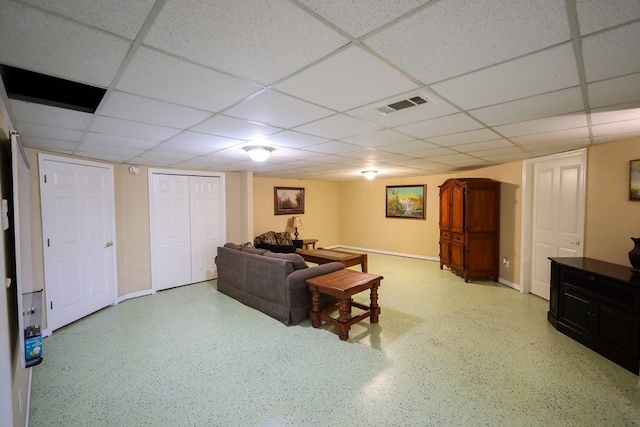 living room with a drop ceiling